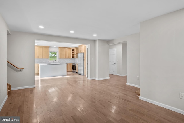 unfurnished living room featuring light hardwood / wood-style floors