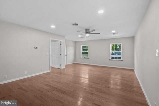 spare room with ceiling fan and wood-type flooring