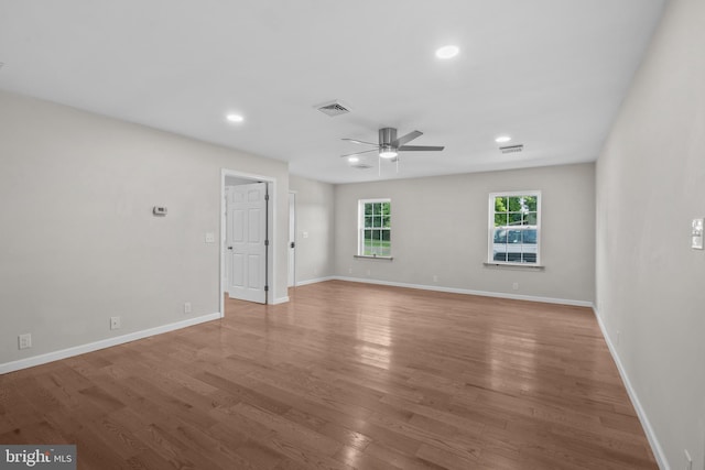 unfurnished room with recessed lighting, visible vents, ceiling fan, wood finished floors, and baseboards