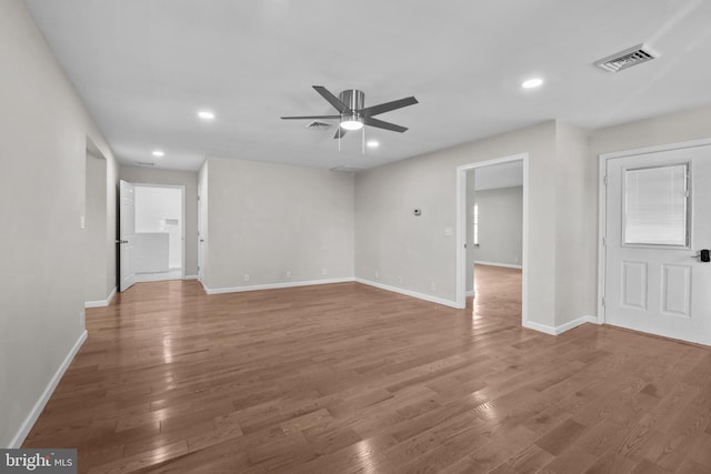 empty room with baseboards, visible vents, a ceiling fan, wood finished floors, and recessed lighting