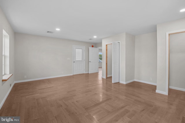 unfurnished room featuring recessed lighting, visible vents, baseboards, and parquet flooring