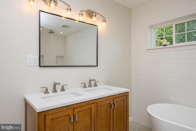 bathroom featuring vanity, tile walls, and a tub