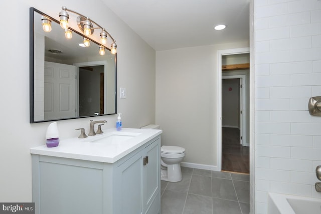 full bath with toilet, tile patterned flooring, vanity, and baseboards