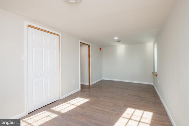 unfurnished bedroom with a closet and wood-type flooring