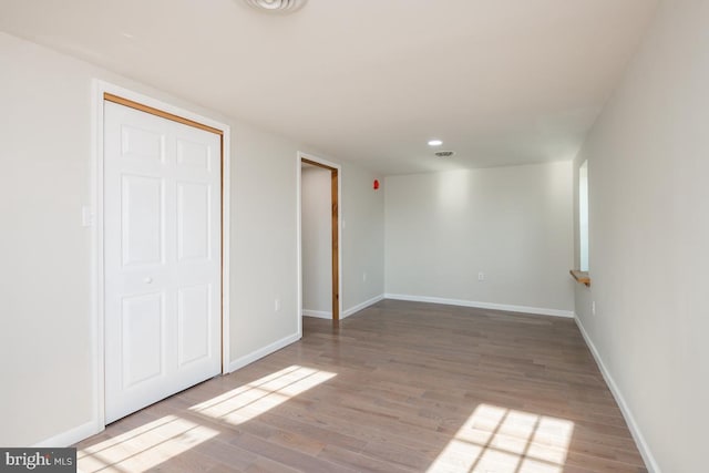 interior space featuring light wood-style floors, visible vents, baseboards, and recessed lighting