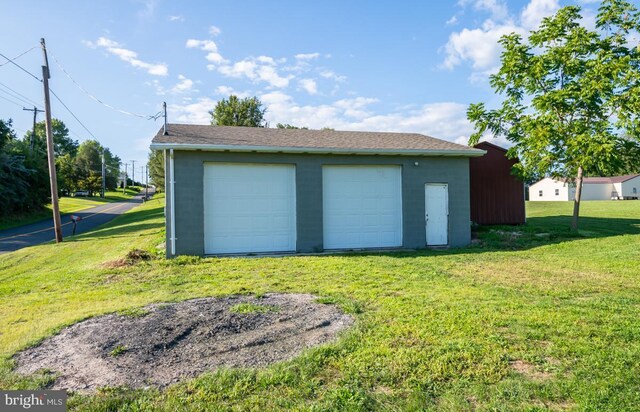 garage featuring a lawn