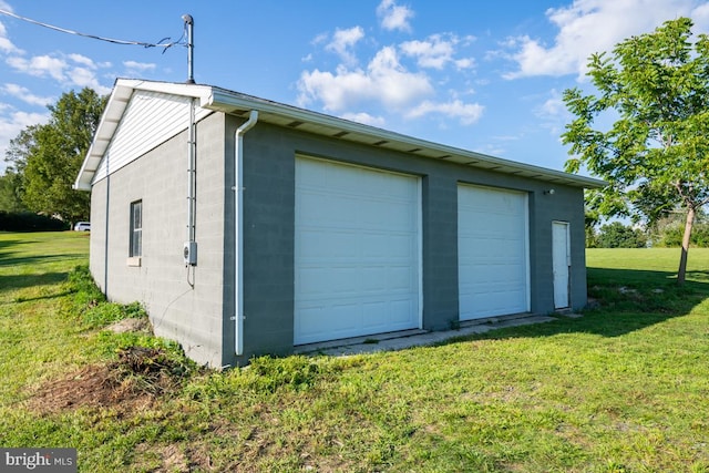 garage featuring a lawn