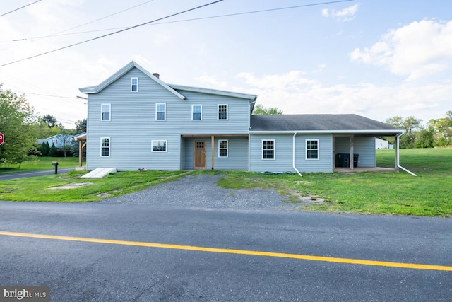 view of front of home with driveway and a front lawn