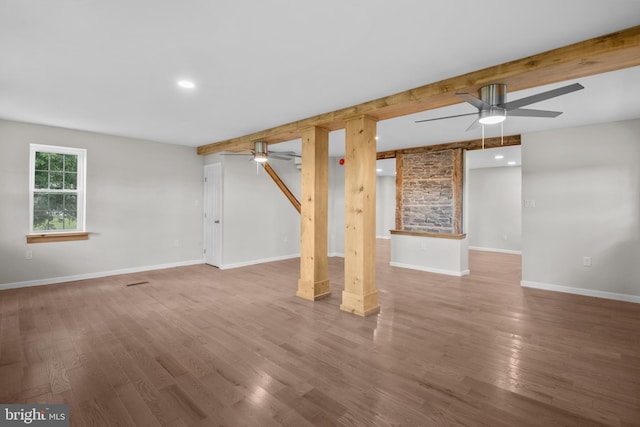 basement featuring ceiling fan and hardwood / wood-style flooring