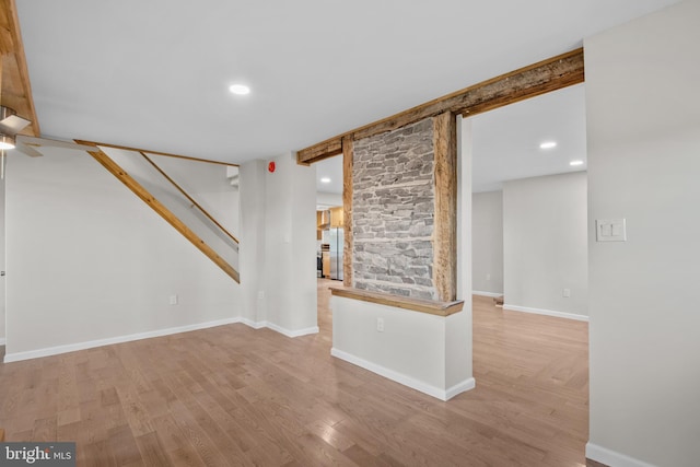 unfurnished living room with light wood-type flooring and ceiling fan