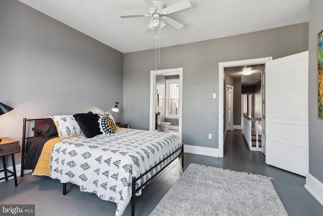 bedroom featuring ceiling fan, connected bathroom, and dark hardwood / wood-style floors