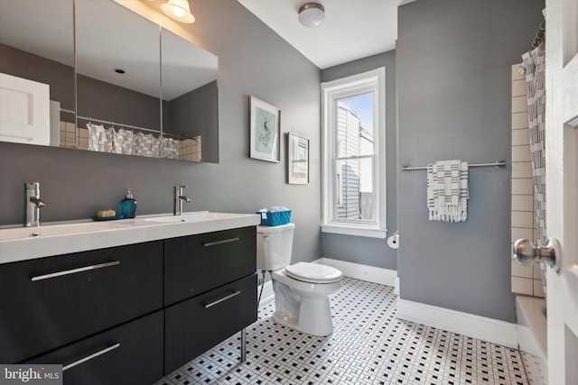 bathroom with tile patterned floors, vanity, and toilet