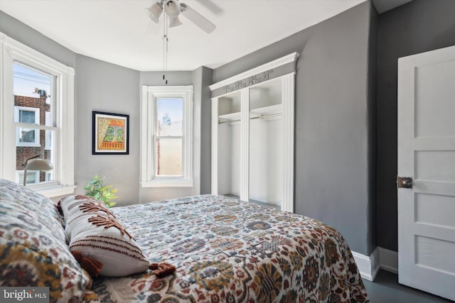 bedroom featuring ceiling fan and a closet