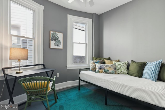 living area featuring carpet flooring and ceiling fan