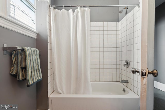 bathroom with shower / bath combo with shower curtain