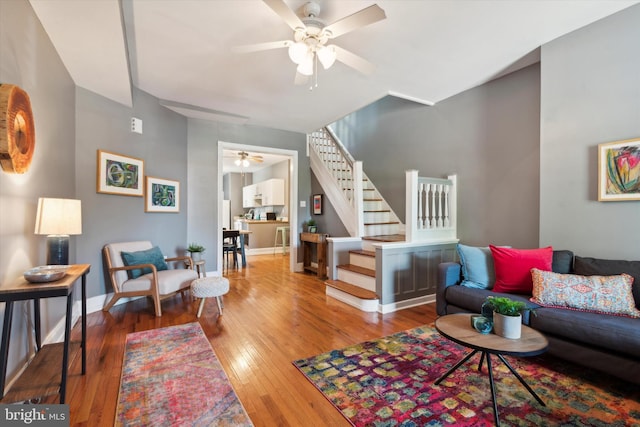 living room with hardwood / wood-style flooring and ceiling fan