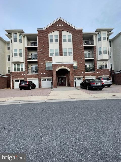 view of front of home featuring a balcony and a garage