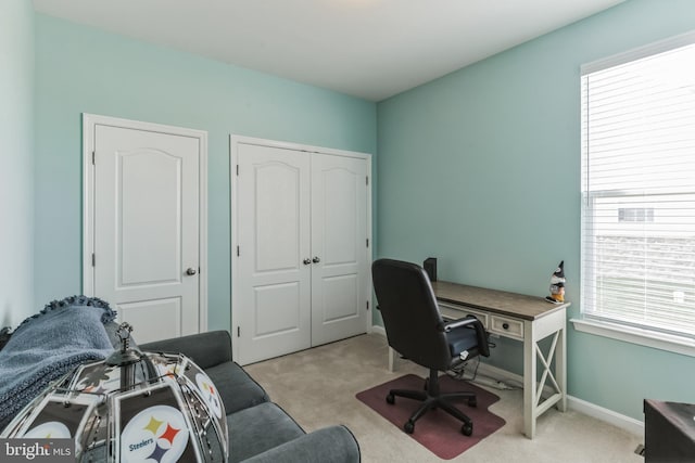 carpeted office space featuring a healthy amount of sunlight