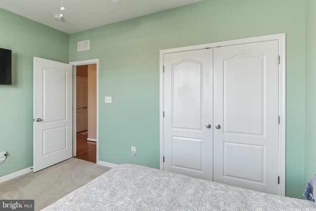 carpeted bedroom with a closet