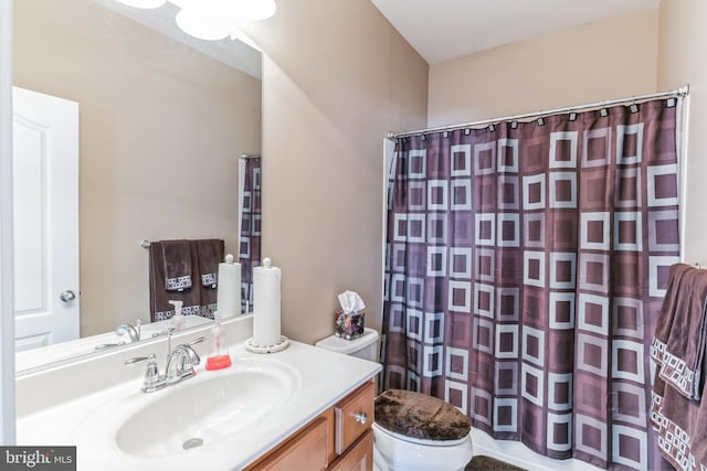 bathroom featuring vanity and toilet