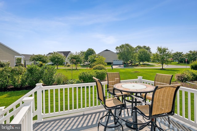 wooden terrace with a lawn