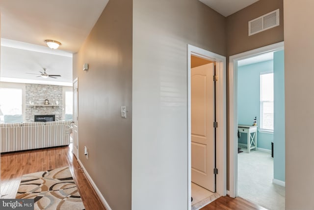 hallway featuring light colored carpet