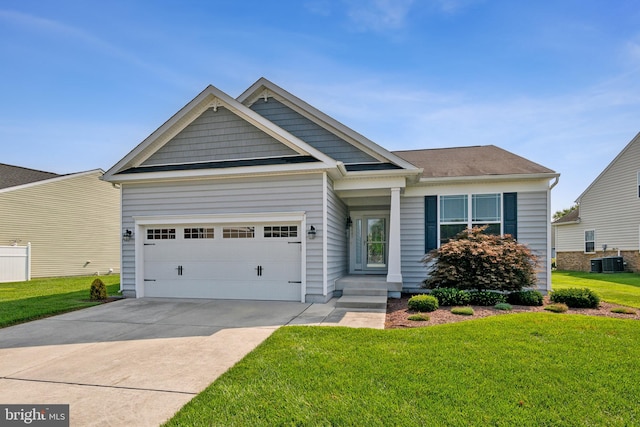 craftsman inspired home with a garage, central AC, and a front yard