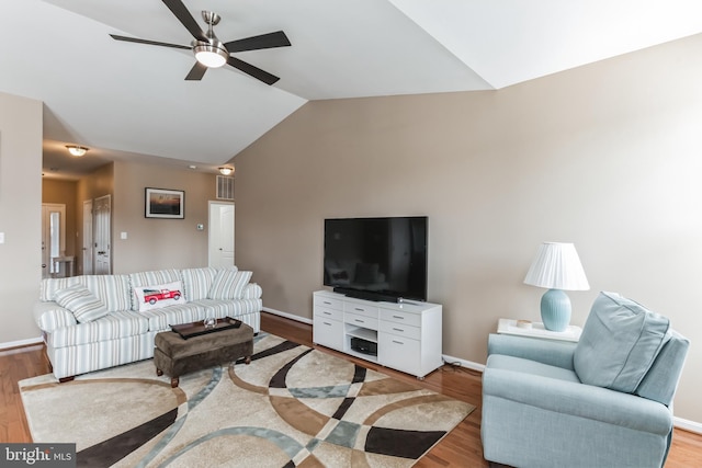 living room with ceiling fan, light wood-type flooring, and lofted ceiling