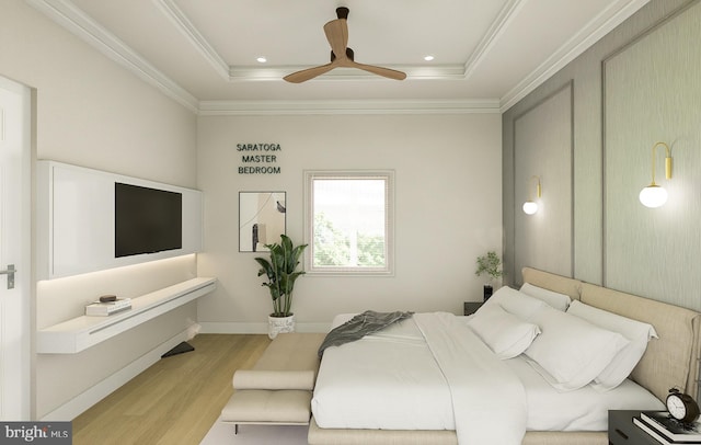 bedroom with crown molding, a raised ceiling, ceiling fan, and light wood-type flooring