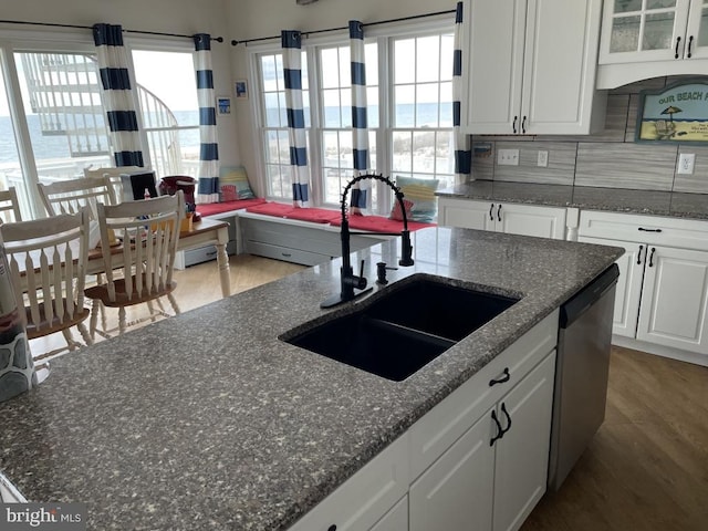 kitchen with white cabinetry, dishwasher, light wood-type flooring, tasteful backsplash, and sink