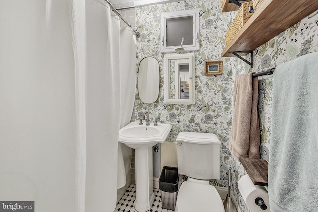 bathroom with tile patterned floors, toilet, and sink