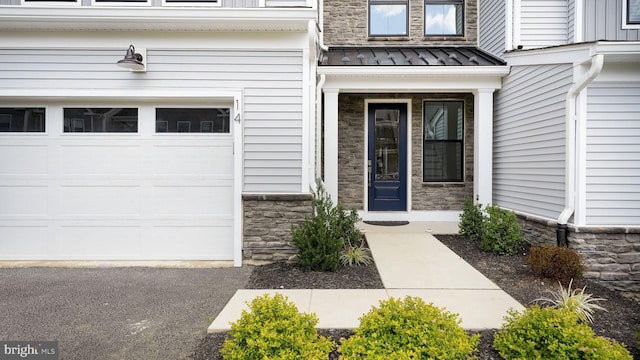 doorway to property featuring stone siding, metal roof, and a standing seam roof