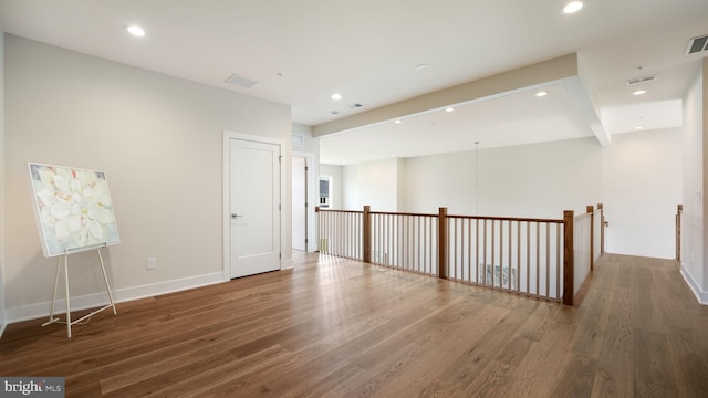 unfurnished room with wood finished floors and recessed lighting