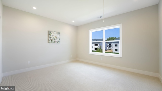 unfurnished room with recessed lighting, carpet floors, visible vents, baseboards, and attic access