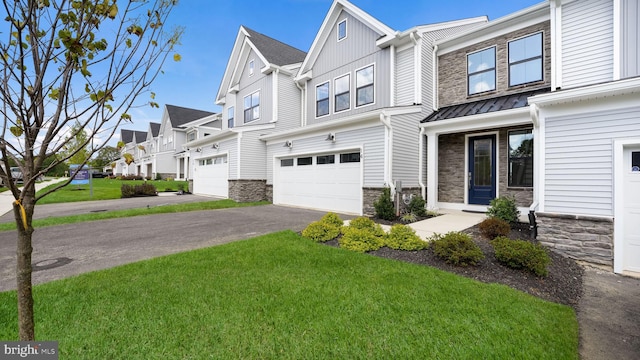 view of property featuring stone siding, a residential view, board and batten siding, and a front yard