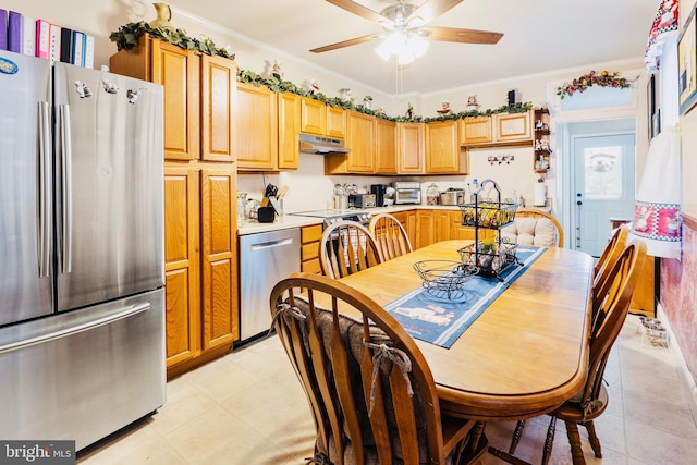 kitchen with ceiling fan, ornamental molding, appliances with stainless steel finishes, and sink