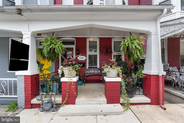 view of exterior entry featuring a porch