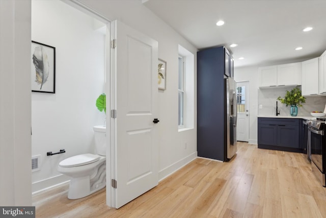 bathroom featuring vanity, toilet, and hardwood / wood-style flooring