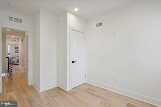 unfurnished room with light hardwood / wood-style floors