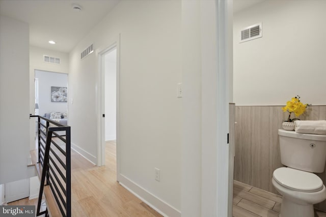 bathroom featuring toilet and wood-type flooring