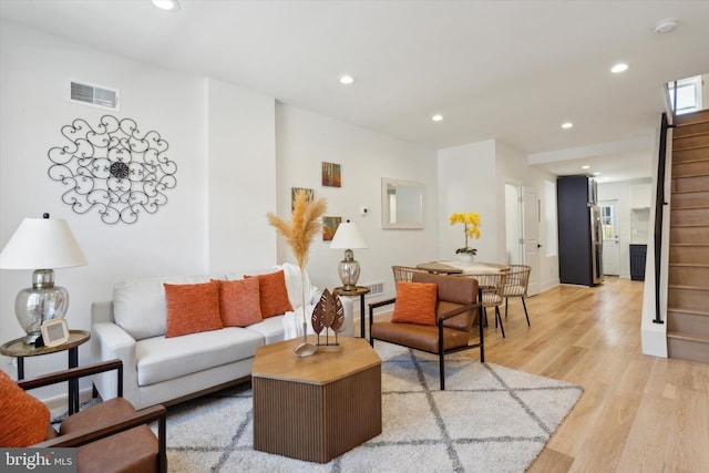 living room with light hardwood / wood-style flooring