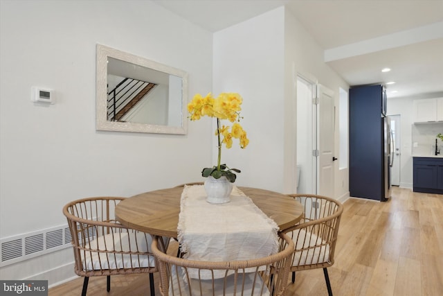 dining space with light hardwood / wood-style floors