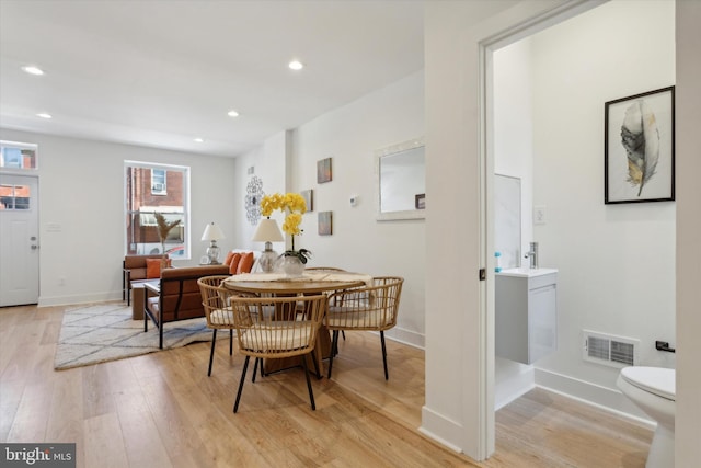 dining room featuring light hardwood / wood-style flooring and sink