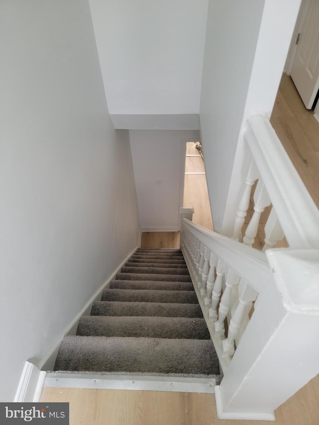 staircase featuring hardwood / wood-style flooring