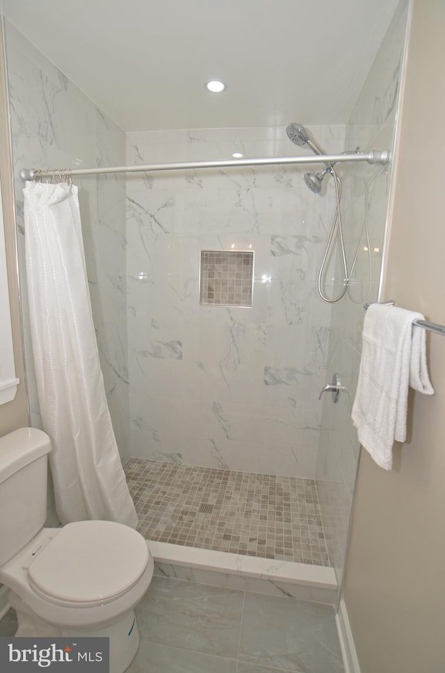 bathroom featuring toilet and a shower with shower curtain