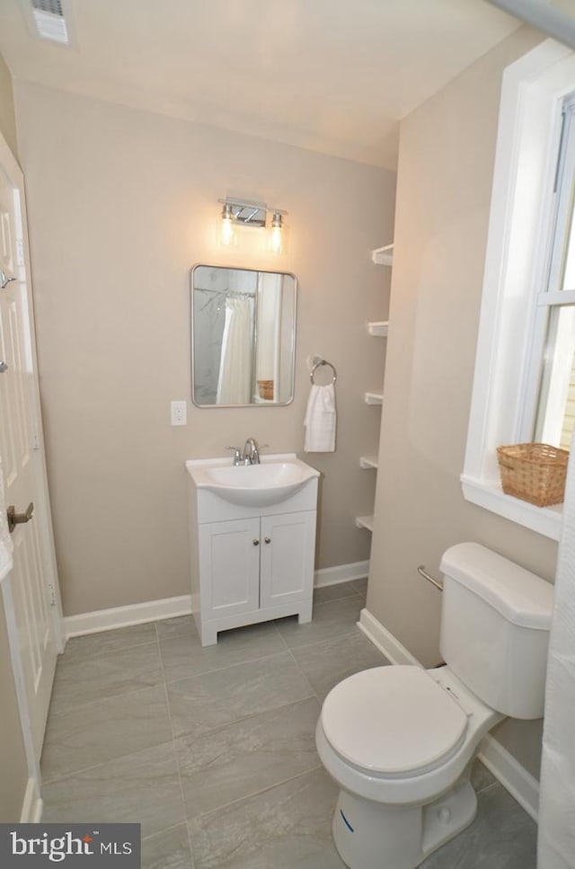 bathroom featuring vanity and toilet