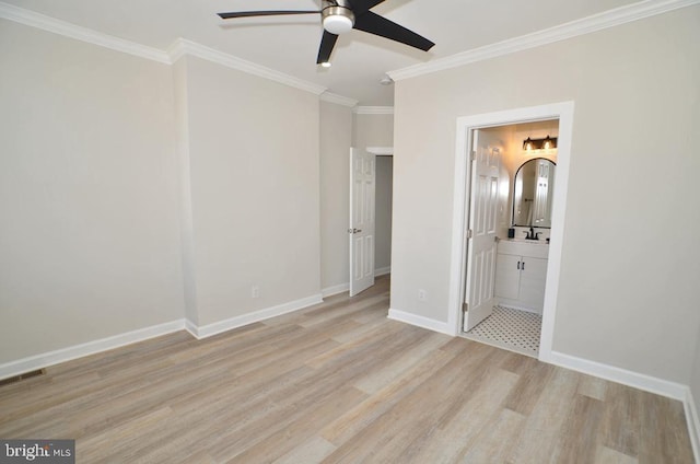 unfurnished bedroom featuring ornamental molding, sink, ensuite bathroom, and light hardwood / wood-style floors