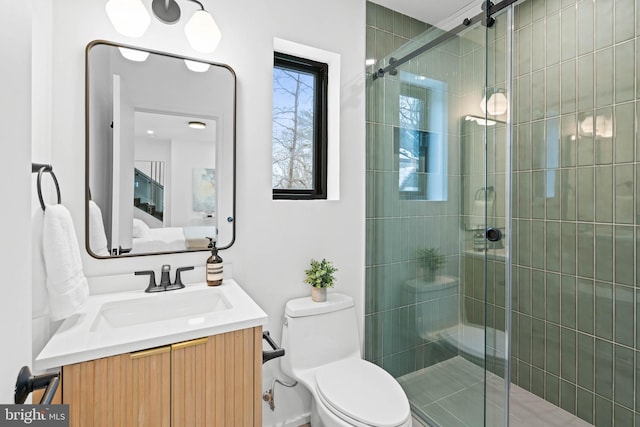 bathroom with toilet, walk in shower, and vanity