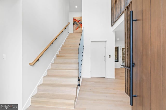 staircase with hardwood / wood-style floors