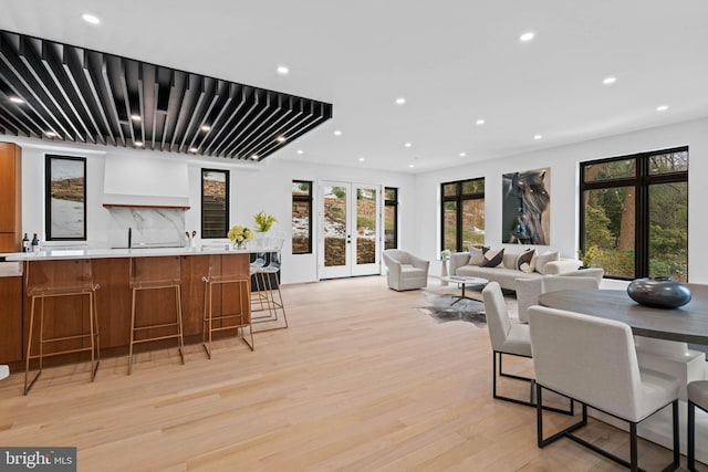 dining room with french doors and light wood-type flooring